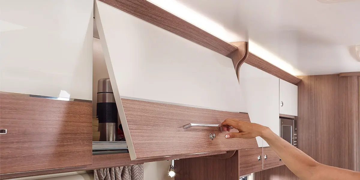 Dual finish ‘Lana Grey’ overhead lockers with ‘Eucalyptus’ contrasting stripe and wide domestic style handle