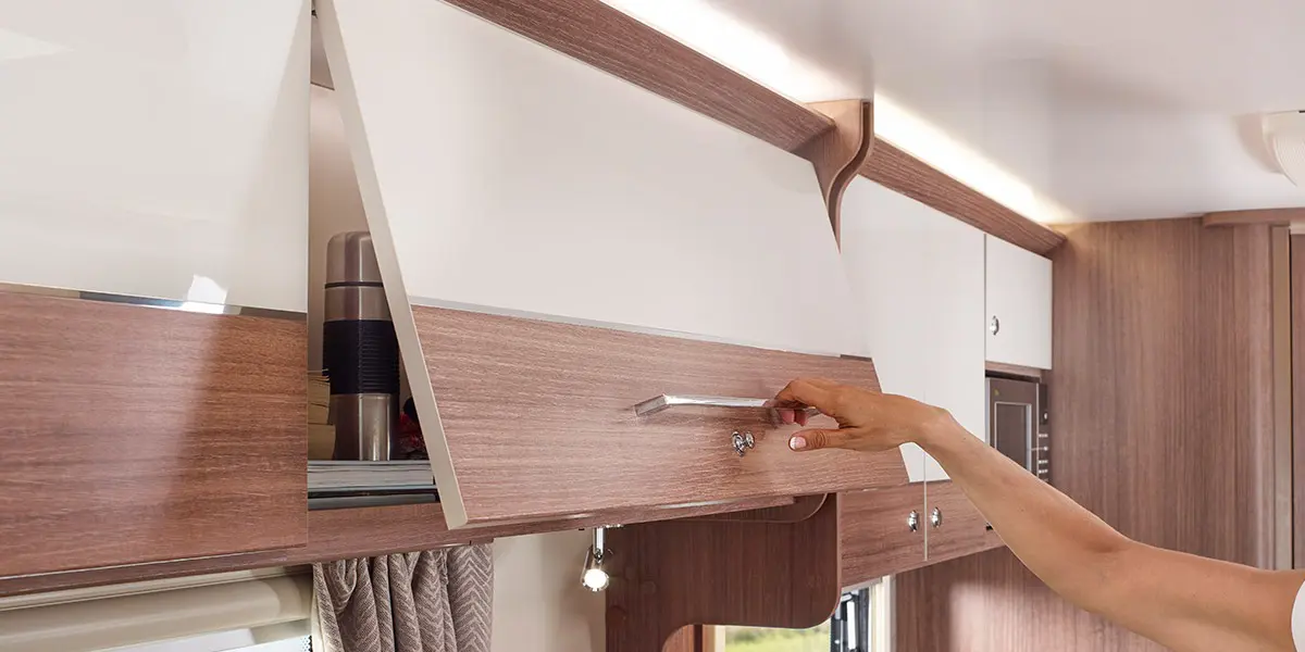 Dual finish ‘Lana Grey’ overhead lockers with ‘Eucalyptus’ contrasting stripe and wide domestic style handle