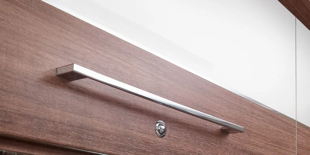 Dual finish ‘Lana Grey’ overhead lockers with ‘Eucalyptus’ contrasting stripe and wide domestic style handle