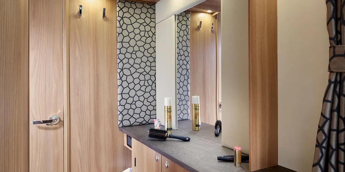 Spacious dressing area with illuminated vanity mirror