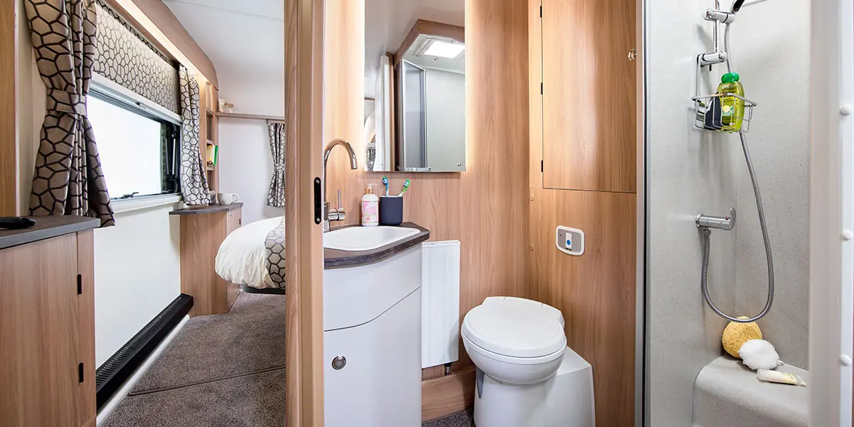 Alicanto Grande Faro bathroom with large ‘Granite Stone’ fully lined shower cubicle with bi-fold partition door and integral lighting