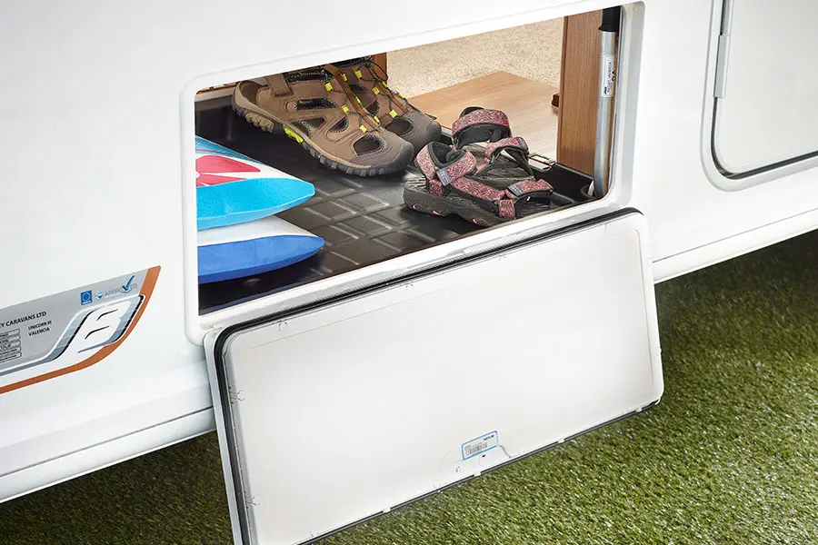 Centrally located easy-access large exterior storage locker with moulded liner
