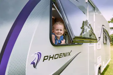 The best caravan makes a small child smile as she looks out of its window