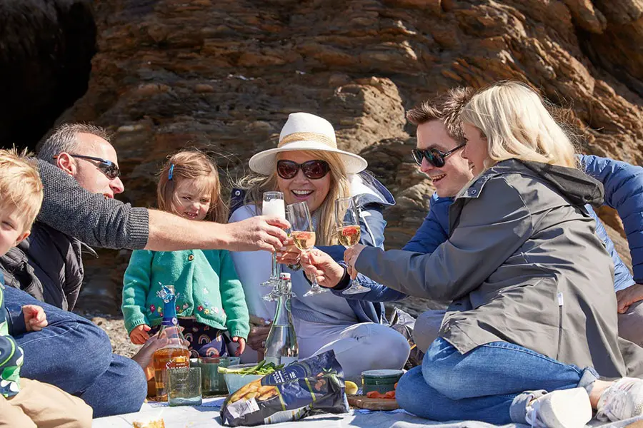 Extended family enjoying a beach picnic together
