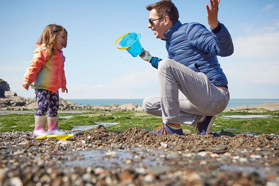 Father and daughter building sandcastles at Hele Bay