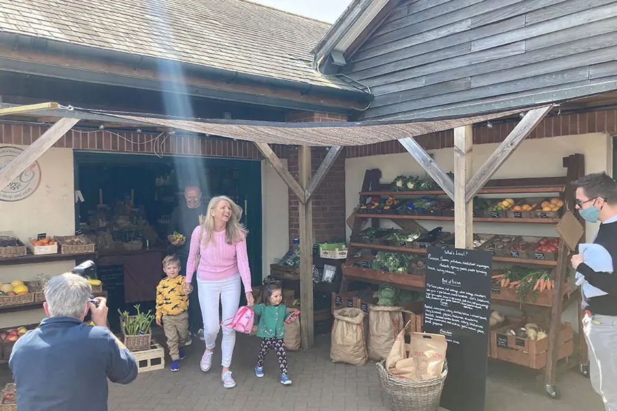 Family leaving The Good Stores farm shop with photographer taking photos
