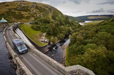 The Bailey Endeavour B62 best campervan for couples driving along a dam.