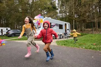 A family next to their Bailey Phoenix GT75 caravan