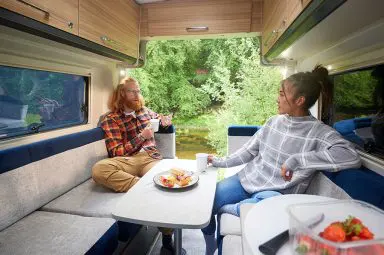 A couple sat at the dining table in their Bailey Endeavour