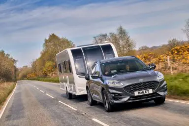 A Bailey Phoenix Black Edition being towed on a UK road