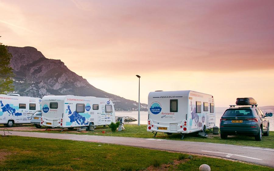 Caravans parked by the seaside in the sunset
