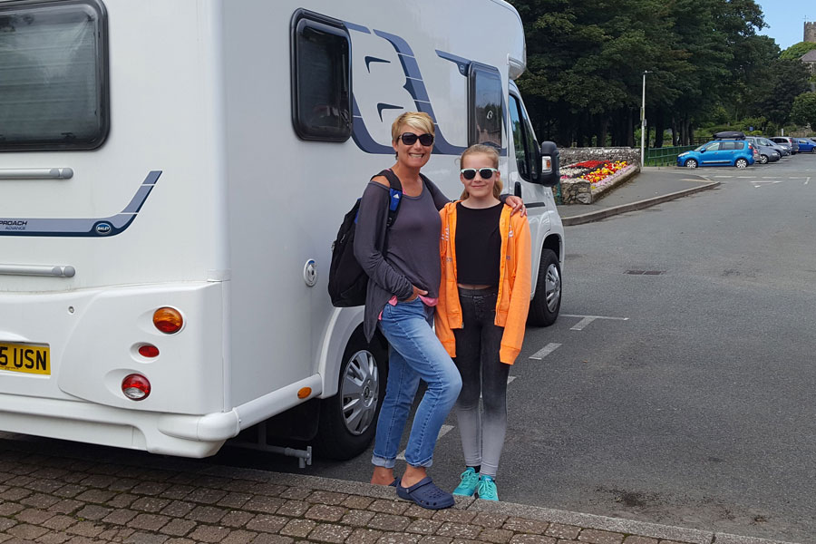 Mother and daughter standing outside motorhome