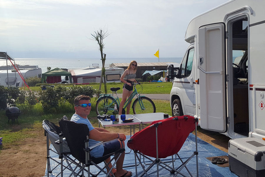 Relaxing in camping chairs outside the motorhome