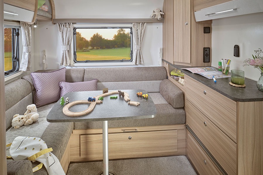 Rear lounge with swivel table and interior access to the rear through boot storage area.