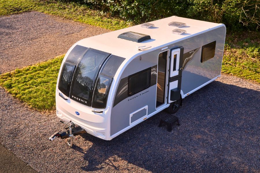 Aerial view of the Phoenix Black Edition 640 parked on a hardstanding pitch, highlighting the panoramic front window and smooth-bodied exterior.