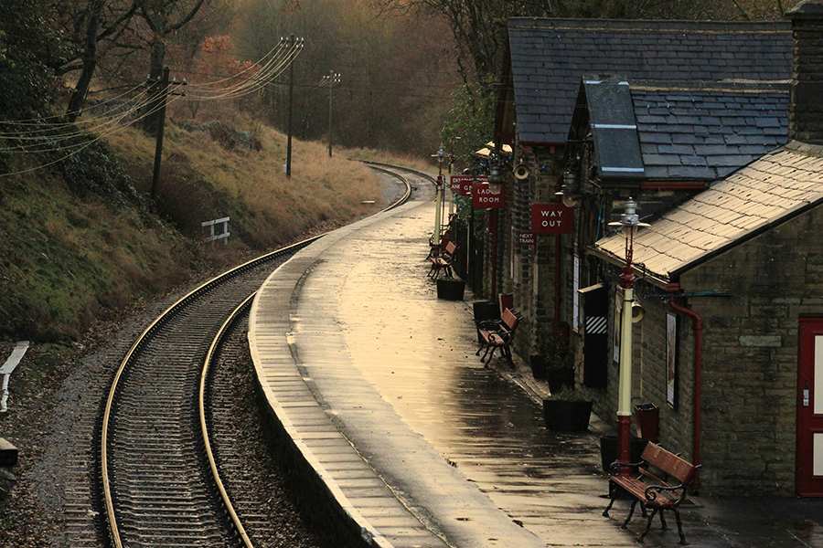 A quaint UK railway station in the evening sun. Photo by Martin King on Unsplash