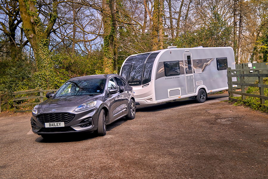 A Bailey Phoenix Black Edition being towed into a campsite
