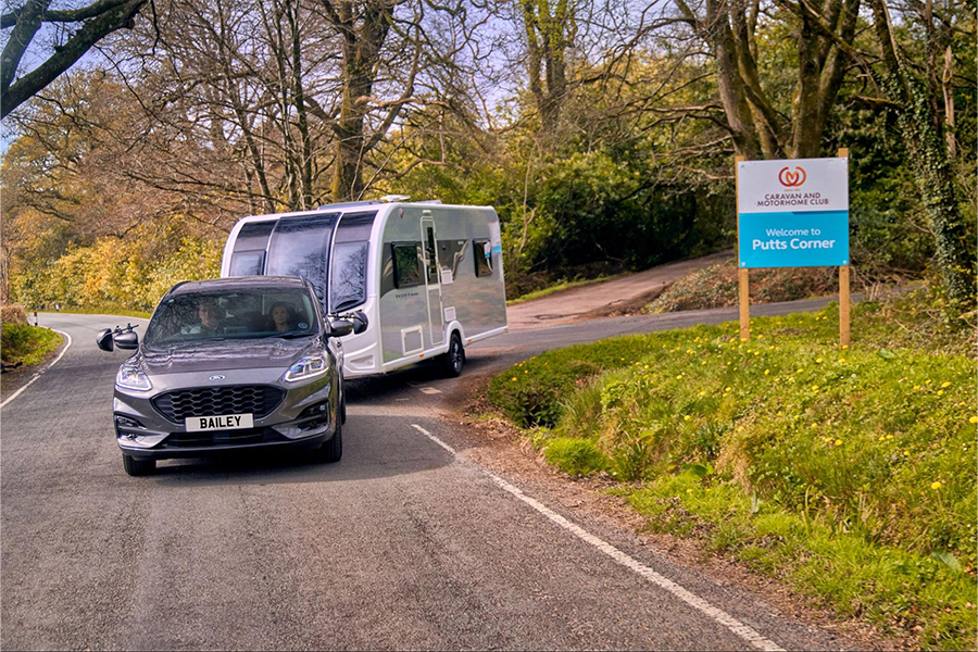 A Bailey Phoenix Black Edition being towed out of a campsite