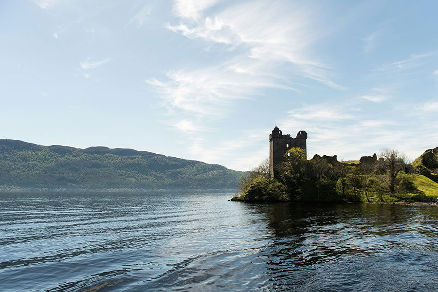 Urquhart Castle in Scotland with Loch Ness next to it.